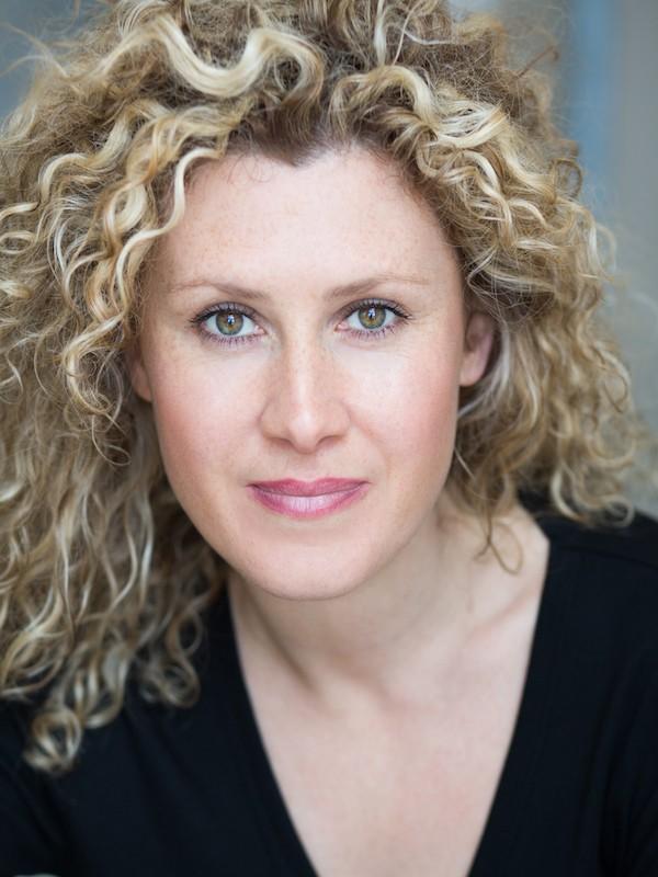 White woman with long blonde curly hair