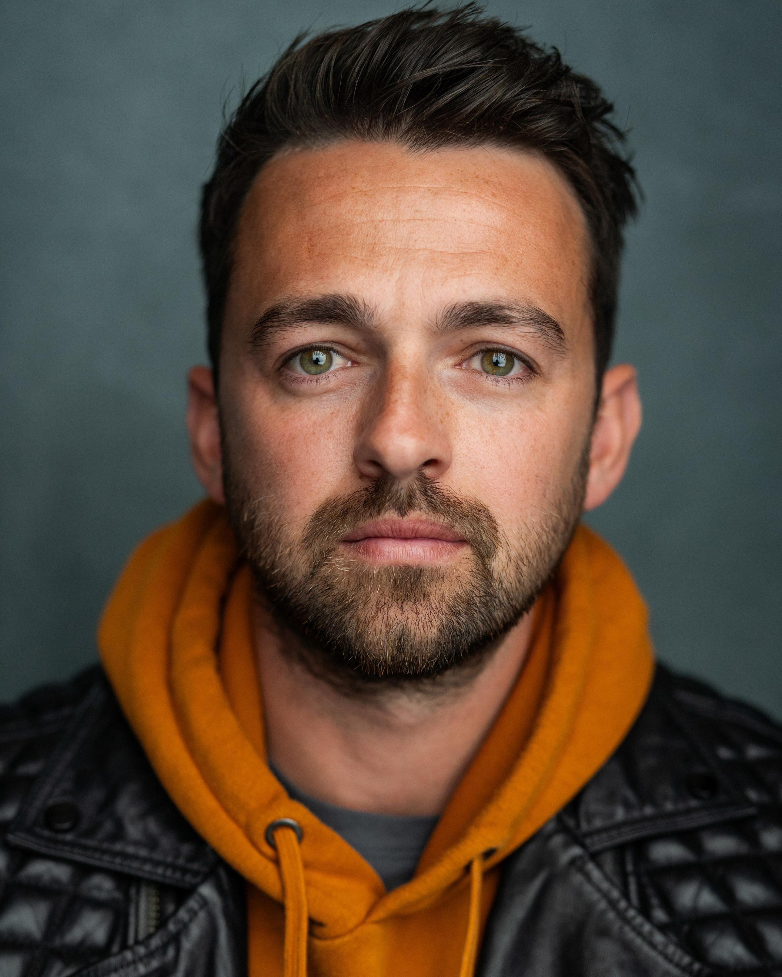 White man in his 30s with brown hair and facial hair