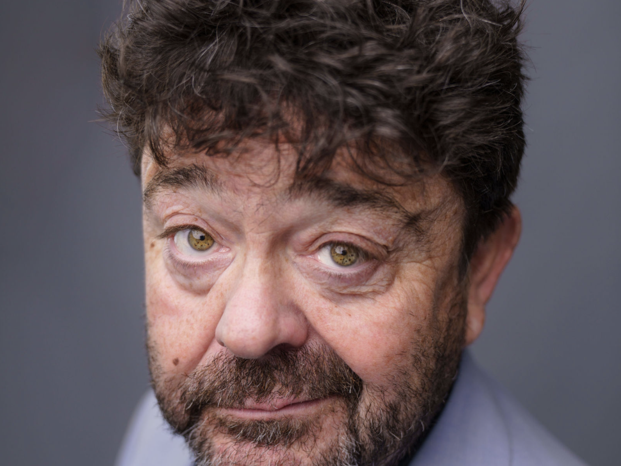 Man with dark hair and dark beard