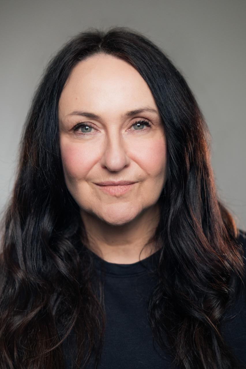 White woman with long, dark brown hair