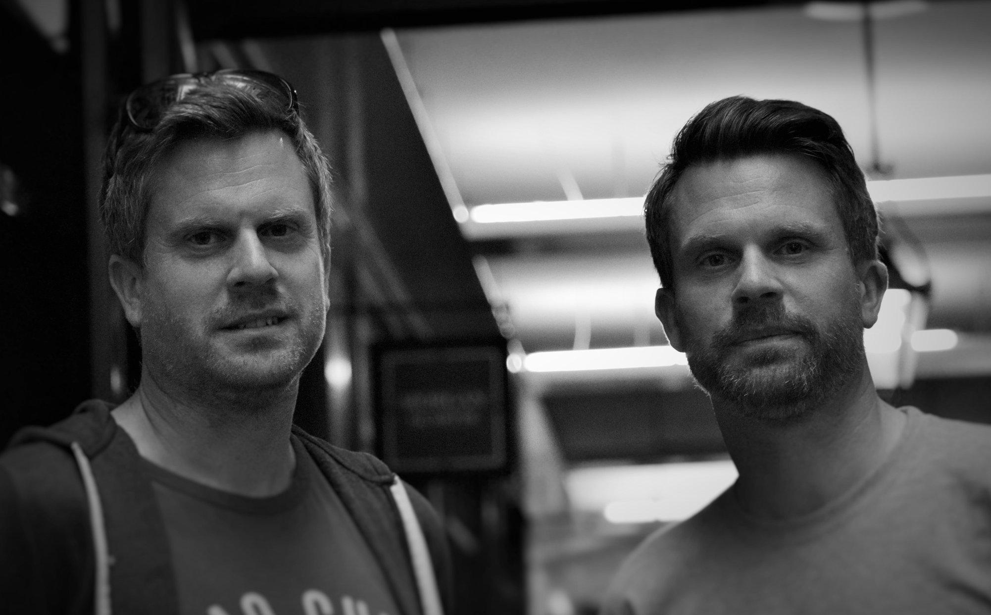 Two white men in black and white stood together