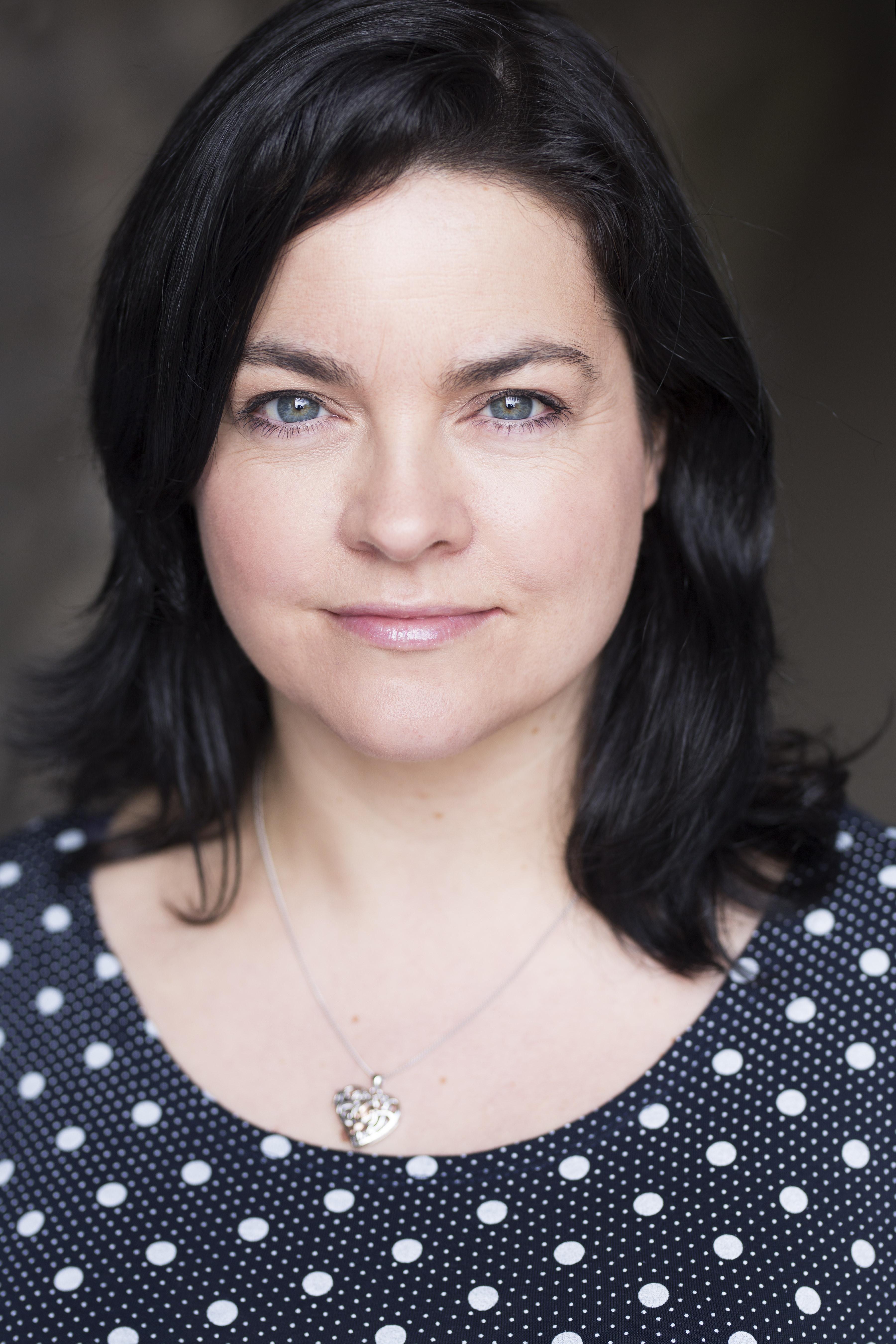White woman with mid length brown hair