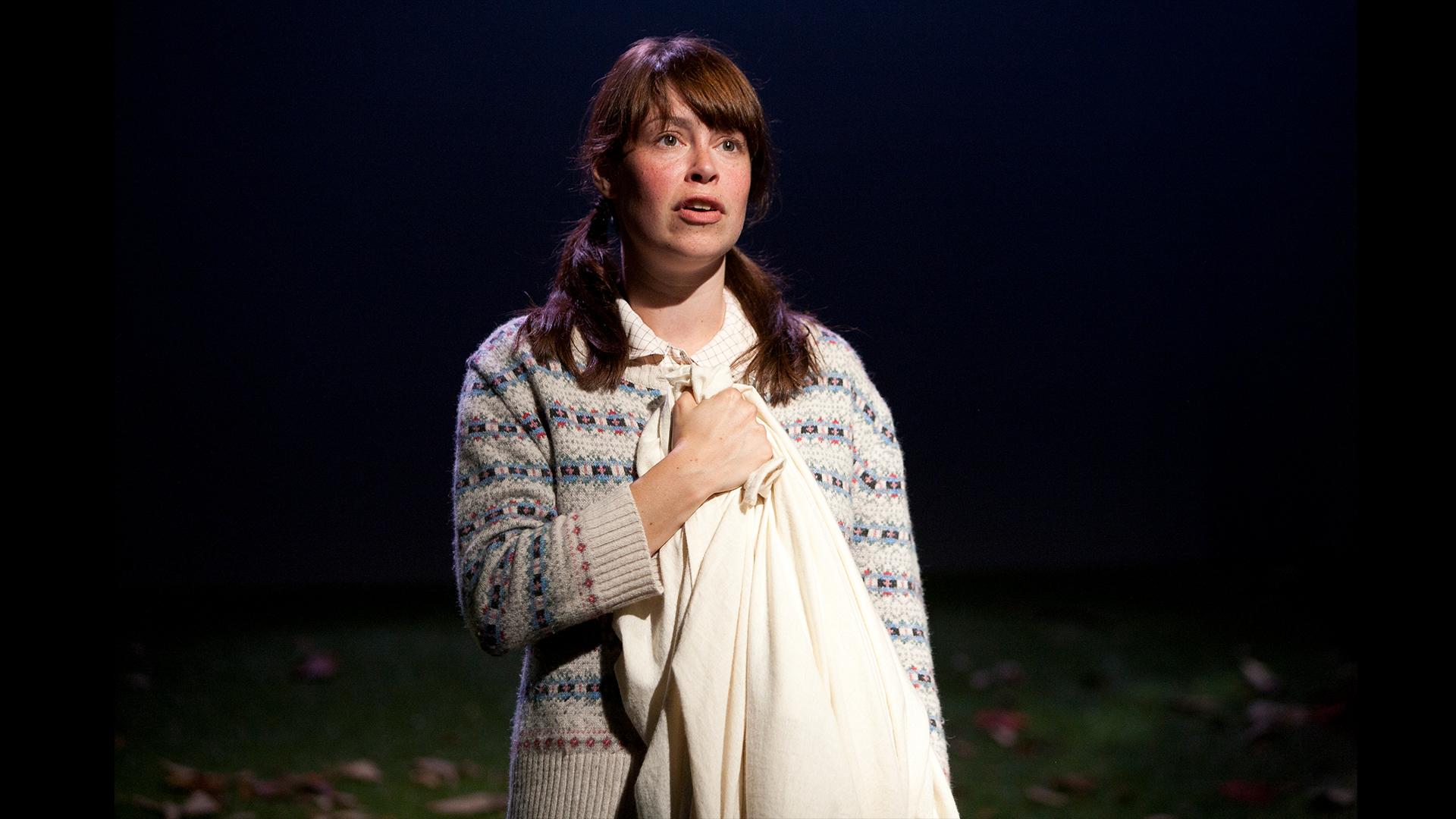 A young girl holding a blanket