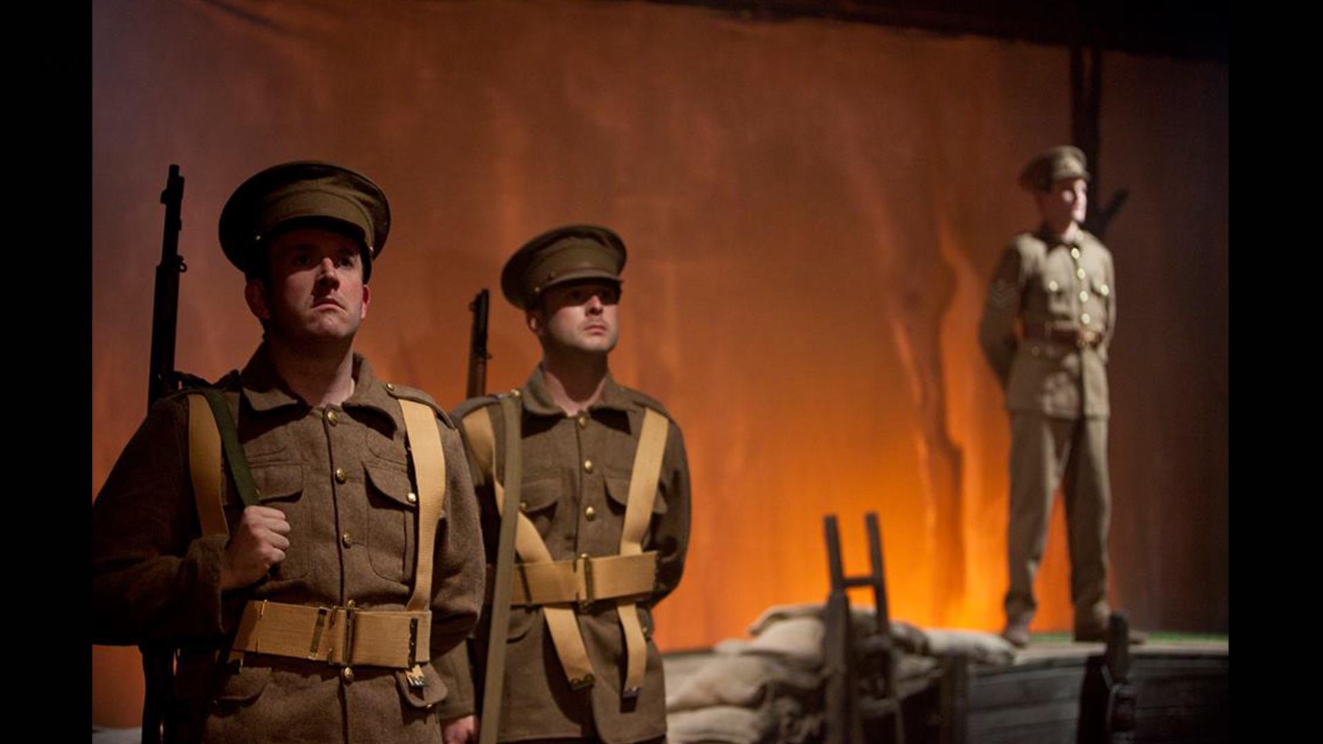 Three soldiers standing tall with an orange background