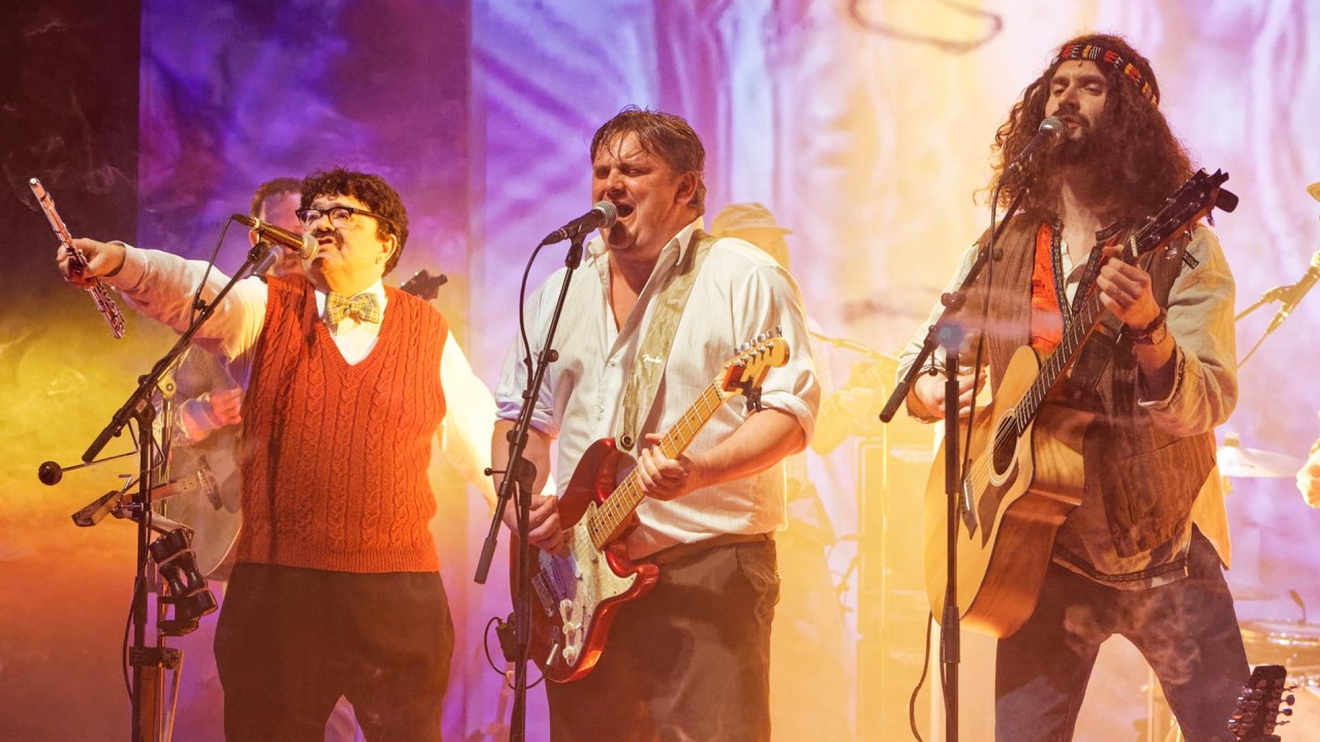 Actors Phylip Harries, Steve Simmonds and Dan Bottomley playing guitars and singing