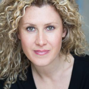 White woman with long blonde curly hair