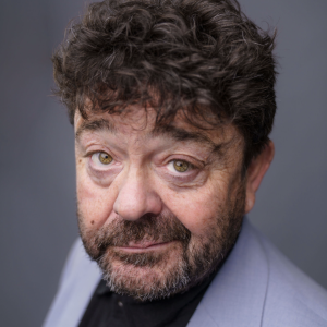 Man with dark hair and dark beard