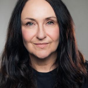 White woman with long, dark brown hair